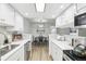 Open kitchen view leading to a dining area with updated appliances and countertops at 3450 S Eagle St # 101, Aurora, CO 80014