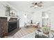 Bright living room featuring a stone fireplace, ceiling fan, and neutral decor at 3450 S Eagle St # 101, Aurora, CO 80014