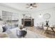 Inviting living room with a stone fireplace, ceiling fan, and sliding door to a balcony at 3450 S Eagle St # 101, Aurora, CO 80014