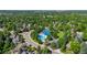 Community aerial view featuring pool, tennis courts, mature trees, and neighborhood layout at 5991 S Eudora Way, Centennial, CO 80121