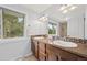 Bathroom featuring a double vanity, granite countertop, and a large mirror with light fixtures at 5991 S Eudora Way, Centennial, CO 80121