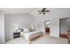Serene bedroom with neutral tones, ensuite bathroom, and vaulted ceilings with fan at 5991 S Eudora Way, Centennial, CO 80121