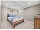 Basement bedroom with a wooden bed frame, neutral walls, and recessed lighting at 5991 S Eudora Way, Centennial, CO 80121