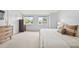 Well-lit bedroom with hardwood floors, dresser, and two windows at 5991 S Eudora Way, Centennial, CO 80121