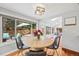 Cozy dining area with large windows overlooking the backyard and a round table at 5991 S Eudora Way, Centennial, CO 80121