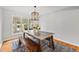 Stylish dining room featuring a modern light fixture, bench seating, and views of the backyard at 5991 S Eudora Way, Centennial, CO 80121