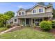 Charming home featuring manicured landscaping, a covered porch, and a classic exterior at 5991 S Eudora Way, Centennial, CO 80121