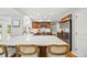 Bright kitchen showcasing an island with seating, modern appliances, and ample counter space at 5991 S Eudora Way, Centennial, CO 80121