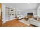 Inviting living room featuring hardwood floors, custom built-ins, and ample natural light at 5991 S Eudora Way, Centennial, CO 80121