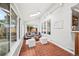 Cozy sunroom features a vaulted ceiling, ample windows, and access to the backyard at 5991 S Eudora Way, Centennial, CO 80121