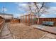 Landscaped backyard features a charming greenhouse, wooden deck, and privacy fence, ideal for gardening and relaxation at 1435 Lipan St, Denver, CO 80204