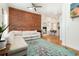 Stylish living room features exposed brick, hardwood floors, and an open layout to the kitchen at 1435 Lipan St, Denver, CO 80204