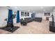 Finished basement with comfortable seating, exercise equipment, and ample space for recreation at 9765 Merimbula St, Highlands Ranch, CO 80130