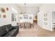 Open dining space featuring a modern chandelier, adjacent to a comfortable living area at 9765 Merimbula St, Highlands Ranch, CO 80130