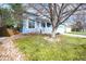 Charming light blue house with landscaped front yard and mature trees on a sunny day at 9765 Merimbula St, Highlands Ranch, CO 80130