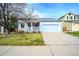 Charming light blue single-Gathering home with well-maintained lawn and two car garage at 9765 Merimbula St, Highlands Ranch, CO 80130