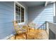 Inviting covered porch with stylish wicker chairs and a cozy outdoor rug at 9765 Merimbula St, Highlands Ranch, CO 80130