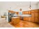 Spacious kitchen with stainless steel appliances, wood cabinets, and hardwood floors at 9765 Merimbula St, Highlands Ranch, CO 80130