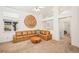 Inviting living room with a comfortable leather sectional, decorative wall art, and neutral carpeting at 9765 Merimbula St, Highlands Ranch, CO 80130
