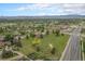 Nice aerial view of neighborhood featuring mature trees, green spaces, and well-maintained roadways at 7930 Alkire St, Arvada, CO 80005