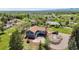 Expansive home on large lot featuring a front circular driveway, landscaped grounds, and mountain views in the distance at 7930 Alkire St, Arvada, CO 80005