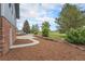 Landscaped backyard featuring mulched garden beds and a concrete pathway at 7930 Alkire St, Arvada, CO 80005