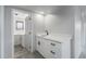 Basement bar area featuring white cabinets, marbled countertops, and a sleek black faucet at 7930 Alkire St, Arvada, CO 80005