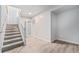 Finished basement showcases new neutral paint and new laminate floors, leading to carpeted stairs at 7930 Alkire St, Arvada, CO 80005