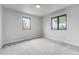 Bright bedroom with new neutral carpeting, natural light and windows with outdoor views at 7930 Alkire St, Arvada, CO 80005