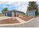 Detached garage and small shed with matching paint and trim, as well as nicely landscaped yard space at 7930 Alkire St, Arvada, CO 80005