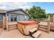Backyard hot tub with stairs on a wooden deck near the house at 7930 Alkire St, Arvada, CO 80005