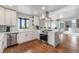 Bright modern kitchen with stainless steel appliances, marble countertops, and hardwood floors at 7930 Alkire St, Arvada, CO 80005