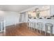 Open-concept view of kitchen bar with seating, stainless appliances, and light grey interior at 7930 Alkire St, Arvada, CO 80005