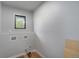 Bright, empty laundry room with window and hookups for washer and dryer at 7930 Alkire St, Arvada, CO 80005