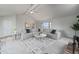 Open concept living room space with carpeted floors and views into the kitchen area at 7930 Alkire St, Arvada, CO 80005