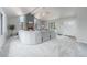 Bright living room with a cozy fireplace, vaulted ceilings, large windows and an over-sized sectional sofa at 7930 Alkire St, Arvada, CO 80005