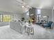 Open concept living room area with a fireplace, vaulted ceilings, and large windows offering great views at 7930 Alkire St, Arvada, CO 80005