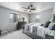 Inviting primary bedroom filled with natural light, featuring a ceiling fan and contemporary design at 7930 Alkire St, Arvada, CO 80005
