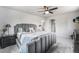 Spacious primary bedroom featuring a luxurious king bed, ceiling fan and ensuite bathroom at 7930 Alkire St, Arvada, CO 80005