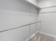 A practical walk-in closet with shelving for optimal organization and well-maintained neutral carpet flooring at 7930 Alkire St, Arvada, CO 80005