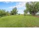 Spacious grassy yard with young trees and a wooden fence at 7930 Alkire St, Arvada, CO 80005