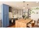 Modern kitchen with stainless steel appliances and butcher block island at 4570 E Yale Ave # 306, Denver, CO 80222