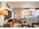 Living room with hardwood floors, built-in shelving and balcony access at 4570 E Yale Ave # 306, Denver, CO 80222