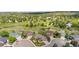 Aerial view of several homes with well-manicured lawns close to a golf course at 8922 S Tuscany Ln, Highlands Ranch, CO 80130