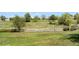 Picture of a golf course with well-manicured lawns and a wooden fence at 8922 S Tuscany Ln, Highlands Ranch, CO 80130