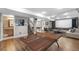 Spacious finished basement with an open floor plan, featuring a ping pong table and movie screen at 8922 S Tuscany Ln, Highlands Ranch, CO 80130