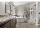 Elegant bathroom showcasing a freestanding tub, glass-enclosed shower, and stylish granite-topped vanity at 8922 S Tuscany Ln, Highlands Ranch, CO 80130