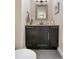Elegant powder room with a dark vanity and neutral wall paint at 8922 S Tuscany Ln, Highlands Ranch, CO 80130