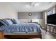 Bedroom with comfortable bed, modern lighting, and large window at 8922 S Tuscany Ln, Highlands Ranch, CO 80130