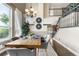 Inviting dining area with a rustic table setting, modern decor, and a view to the staircase at 8922 S Tuscany Ln, Highlands Ranch, CO 80130